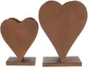 Two heart-shaped planters with a rustic, rusted metal appearance, each standing on a rectangular base. Voir les images du produit