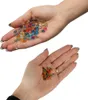 Two hands holding gel beads, one hand with larger beads and the other with smaller beads. Náhled obrázku produktu