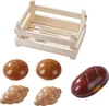 A wooden crate and various toy bread items are arranged on a white background. Produktbild-Vorschau