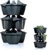 A stack of dark gray modular planters, with a smaller stack of planters containing plants on the right. Náhľad obrázku produktu