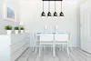 A dining room with a table and chairs, a dresser with plants, and a pendant light fixture. Produktbild-Vorschau