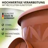 Close-up of a terracotta-colored plant pot with text highlighting its features and origin. Produktbild-Vorschau