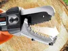 A close-up of a Black & Decker electric pruning shear against a wooden background. Produktbild-Vorschau
