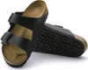 A pair of black Birkenstock Arizona sandals shown from a diagonal angle against a white background. Produktbild-Vorschau