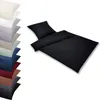 A black duvet cover and pillowcase set is displayed on a white background, with a stack of other colored bedding sets to the left. Produktbild-Vorschau