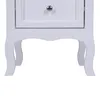 A close-up view of the bottom part of a white nightstand, showing its decorative legs and the bottom of a drawer. Anteprima dell’immagine prodotto
