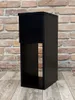 A black bedside table with a drawer and shelf is shown against a brick wall and wooden floor. Náhled obrázku produktu