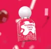 A bottle of Tubbees Cherry Luxe Eau de Parfum against a vibrant pink background with blurred elements. Náhľad obrázku produktu