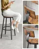 A person sitting on a bar stool with close-up shots highlighting the stool's design. Náhled obrázku produktu