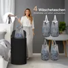 A woman is demonstrating how to use a laundry basket with removable bags. Produktbild-Vorschau