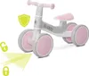 A light gray and pink balance bike with pink handlebars and seat, shown on a white background with graphic overlays. Náhľad obrázku produktu