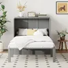 A grey murphy bed is set up in a bedroom with pillows and a blanket on it. There is a plant and a radio on the shelf above the bed. Produktbild-Vorschau