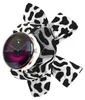 A smartwatch with a cow-print band is displayed against a white background. Podgląd zdjęcia produktu