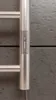 A close-up of a chrome electric towel rail with a digital display and control panel. Produktbild-Vorschau