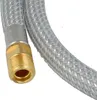 A close-up view of a braided metal hose with a brass fitting. Produktbild-Vorschau