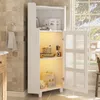 A white corner cabinet with glass doors, open shelves, and LED lighting, placed in a bathroom setting with tiled walls and a window view. Produktbild-Vorschau