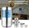 A woman is filling a glass with filtered water from a faucet in a kitchen. Produktbild-Vorschau
