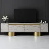 A TV stand with a television on top, in a room with a dark gray wall and a light-colored floor. Produktbild-Vorschau
