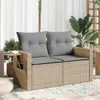 A beige poly rattan sofa with gray cushions is shown on a patio with plants and curtains in the background. Náhľad obrázku produktu
