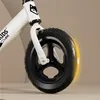 Close-up of a white balance bike wheel and fork. Náhled obrázku produktu