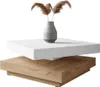 A modern coffee table with a white top and a wood-grain base, decorated with a vase of dried reeds. Produktbild-Vorschau