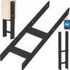 A product shot of black metal H-shaped column feet, with a wooden post attached to one of them to show its use. Podgląd zdjęcia produktu