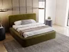 A bedroom scene featuring a green upholstered bed with bedding, a rug, and a bedside table. Produktbild-Vorschau