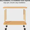 A two-tiered wooden table with wheels, shown in an assembly or demonstration context. Produktbild-Vorschau