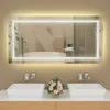 A modern bathroom vanity with two sinks, a large illuminated mirror, and a floral arrangement. Náhled obrázku produktu