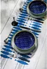 A table setting with plates, cutlery, and a wine glass on a table runner with a fish pattern. Voir les images du produit