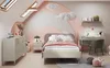 A child's bedroom with a bed, desk, and dresser, decorated with a rainbow mural and clouds. Produktbild-Vorschau