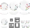 A collage of images showing a dinnerware set with floral patterns, including plates, bowls, and mugs, along with icons indicating product features. Produktbild-Vorschau