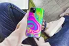 A person holding a phone with a colorful, psychedelic case while sitting down. Produktbild-Vorschau