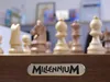A close-up view of a Millennium chess set with the brand name visible on the front. Podgląd zdjęcia produktu