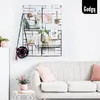 A living room scene with a couch and a wall grid decorated with various items. Produktbild-Vorschau