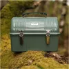 A green Stanley lunch box sits on a moss-covered log in a forest setting. Podgląd zdjęcia produktu