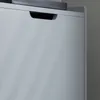 A close-up view of a gray cabinet with a black handle. Produktbild-Vorschau