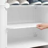 A hand is shown adjusting a shelf in a white modular closet or shoe rack. Náhľad obrázku produktu