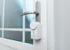 A white electronic door lock mechanism attached to a door handle next to a frosted glass window. Náhľad obrázku produktu