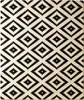 A close-up view of a rug with a diamond pattern. Podgląd zdjęcia produktu