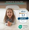 A child lying on a mattress, with certification badges and text overlays. Produktbild-Vorschau