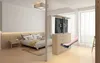 A bedroom with a TV lift cabinet and a hand holding a remote control. Náhled obrázku produktu