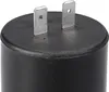 Close-up of the top of a black cylindrical component with two metal prongs. Produktbild-Vorschau