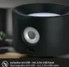 Close-up of a black cylindrical device with a silver ring around a circular feature, and a USB-C port at the bottom. Anteprima dell’immagine prodotto