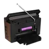 The back of a portable radio with the battery compartment open, showing a battery inside. Voir les images du produit