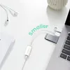 A white desk with a laptop, earphones, and a USB hub. Produktbild-Vorschau
