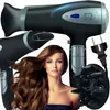 A woman with long, wavy brown hair is shown with a black hairdryer and accessories. Produktbild-Vorschau