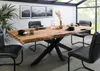 A dining table set in a modern dining room with large windows. Voir les images du produit