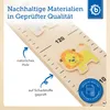 A close-up view of a wooden growth chart with animal illustrations and text indicating quality and material. Produktbild-Vorschau