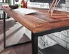 A close-up view of a wooden desk with a black metal frame, showing the edge of the tabletop and one of the legs. Produktbild-Vorschau